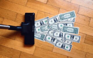 photo of US dollars being vacuumed, inflation concept