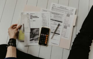 Tax forms, pen and calculator on a desk